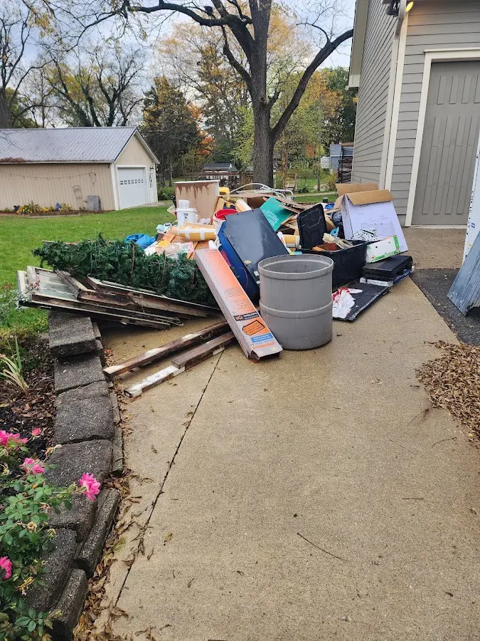 Dumpster being loaded with debris for 12 Yard Dumpster Rental in Bogalusa